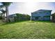 Spacious backyard featuring lush green lawn and fenced perimeter for privacy and security at 1712 Crossvine Ct, Trinity, FL 34655