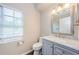 Bathroom featuring updated vanity, marble countertop, and natural light at 1712 Crossvine Ct, Trinity, FL 34655