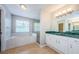 A large bathroom featuring a garden tub with a window, shower, toilet, and double sink at 1712 Crossvine Ct, Trinity, FL 34655