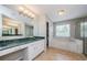 A large bathroom with double sinks, green marble countertop, garden tub, and large window at 1712 Crossvine Ct, Trinity, FL 34655