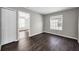 This bedroom showcases vinyl flooring, a window and a door to another room at 1712 Crossvine Ct, Trinity, FL 34655