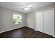 The bedroom offers a ceiling fan, window and double door closet for ample storage at 1712 Crossvine Ct, Trinity, FL 34655