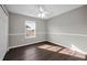 This bedroom features vinyl flooring, a ceiling fan, and a window for natural light at 1712 Crossvine Ct, Trinity, FL 34655