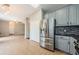 Bright kitchen featuring stainless steel appliances, gray cabinets and sleek backsplash at 1712 Crossvine Ct, Trinity, FL 34655