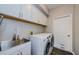 Functional laundry room with a large sink and modern washer and dryer at 1712 Crossvine Ct, Trinity, FL 34655