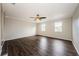 Spacious living room with hardwood floors, a ceiling fan, and large windows at 1712 Crossvine Ct, Trinity, FL 34655