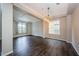 Bright and open living room space with large windows and hardwood floors at 1712 Crossvine Ct, Trinity, FL 34655