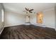 A large living room with hardwood floors, ceiling fan, and steps leading to different levels at 1712 Crossvine Ct, Trinity, FL 34655