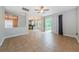 Bright living room boasts tile flooring, ceiling fan, and sliding glass doors leading to the backyard at 1712 Crossvine Ct, Trinity, FL 34655