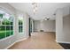 Open floor plan showcasing spacious tiled living area, view of backyard, and easy access to the kitchen at 1712 Crossvine Ct, Trinity, FL 34655