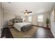 This well-lit bedroom features a stylish ceiling fan, plush bedding, and ample natural light at 1712 Crossvine Ct, Trinity, FL 34655