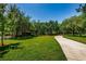 Picturesque park with a winding pathway, a large grassy area, and mature trees, perfect for outdoor activities at 1712 Crossvine Ct, Trinity, FL 34655