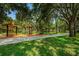 Well-maintained park featuring shady picnic areas, a paved path, and mature trees at 1712 Crossvine Ct, Trinity, FL 34655