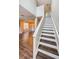 Elegant staircase with hardwood treads and white risers, adding a touch of class at 1712 Crossvine Ct, Trinity, FL 34655