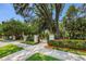 Scenic walking path through a lush green space with mature trees and manicured landscaping at 1712 Crossvine Ct, Trinity, FL 34655