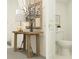 Bathroom featuring decorative table with lamp and decor, and partial view of toilet and doorway at 17518 Happytrails St, Land O Lakes, FL 34638