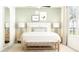 Serene bedroom with neutral tones, a large window, and decorative bedside lamps at 17518 Happytrails St, Land O Lakes, FL 34638