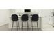 Clean kitchen with an island, and modern stools at 17573 Happytrails St, Land O Lakes, FL 34638
