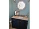 Bathroom vanity with granite countertop, a dark cabinet, and stylish mirror at 17960 Gulf Blvd # 101, Redington Shores, FL 33708