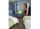 Bedroom showcasing two beds and a view of the laundry closet at 17960 Gulf Blvd # 101, Redington Shores, FL 33708