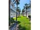 Well-manicured lawns and palm trees lining white condos with balconies at 17960 Gulf Blvd # 101, Redington Shores, FL 33708