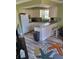 Cozy kitchen featuring sleek countertops, a refrigerator and a view into the living area at 17960 Gulf Blvd # 101, Redington Shores, FL 33708
