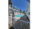 Community pool is surrounded by lounge chairs and palm trees, providing a relaxing outdoor space at 17960 Gulf Blvd # 101, Redington Shores, FL 33708