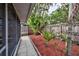 Landscaped backyard with a fence and view of the screened patio at 1955 Cobblestone Way, Clearwater, FL 33760