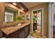 Bathroom featuring a double vanity, granite countertop, and large mirrors at 1955 Cobblestone Way, Clearwater, FL 33760