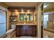 Bathroom showcasing a double vanity with granite countertop and a glass-enclosed shower at 1955 Cobblestone Way, Clearwater, FL 33760