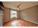 Bedroom with wood floors, window, ceiling fan, and neutral wall color at 1955 Cobblestone Way, Clearwater, FL 33760