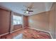 Bedroom with wood floors, window with curtains, and neutral wall color at 1955 Cobblestone Way, Clearwater, FL 33760