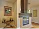 Close-up of a modern fireplace, accompanied by a bar area with wine bottles and glassware at 1955 Cobblestone Way, Clearwater, FL 33760