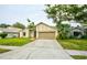 Lovely single-Gathering home with a spacious driveway, attached two-car garage, and vibrant green lawn at 1955 Cobblestone Way, Clearwater, FL 33760