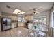 Well-lit kitchen featuring stainless steel appliances, tile flooring, and a cozy breakfast nook with patio access at 1955 Cobblestone Way, Clearwater, FL 33760