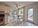 Cozy breakfast nook featuring a glass table, overlooking the screened patio and backyard, adjacent to the kitchen at 1955 Cobblestone Way, Clearwater, FL 33760
