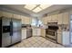Functional kitchen with stainless steel appliances, ample cabinet space, and bright lighting for culinary adventures at 1955 Cobblestone Way, Clearwater, FL 33760