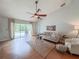Well-lit living room featuring modern furniture, sliding glass doors, and stylish decor, with hardwood floor at 1955 Cobblestone Way, Clearwater, FL 33760