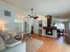 Spacious living room with hardwood floors, fan, fireplace, comfortable sofa, and double front doors at 1955 Cobblestone Way, Clearwater, FL 33760