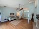 Open living room with hardwood floors, a ceiling fan, and lots of natural light at 1955 Cobblestone Way, Clearwater, FL 33760
