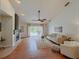 Bright living room features a fireplace, vaulted ceilings, and sliding doors to the backyard pool at 1955 Cobblestone Way, Clearwater, FL 33760