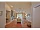 Spacious living room with hardwood floors, a ceiling fan, and sliding glass doors to the patio at 1955 Cobblestone Way, Clearwater, FL 33760