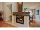 Bright living room boasts a fireplace and a seamless flow into the dining area, perfect for modern living at 1955 Cobblestone Way, Clearwater, FL 33760