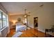 Serene main bedroom with hardwood floors, ceiling fan, and ensuite bathroom access for ultimate comfort and convenience at 1955 Cobblestone Way, Clearwater, FL 33760
