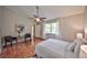 Spacious main bedroom with hardwood floors, large window, and contemporary decor for a relaxing retreat at 1955 Cobblestone Way, Clearwater, FL 33760