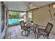 Screened patio with outdoor seating overlooking the swimming pool and backyard at 1955 Cobblestone Way, Clearwater, FL 33760