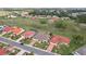 Aerial view of the property showcasing green space, well-manicured lawn, and landscaping at 1972 Wolf Laurel Dr, Sun City Center, FL 33573
