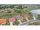Aerial view of the property showcasing green space, well-manicured lawn, and landscaping at 1972 Wolf Laurel Dr, Sun City Center, FL 33573