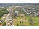 Charming aerial view showcasing a residential area with a meandering walking path and a tranquil pond at 1972 Wolf Laurel Dr, Sun City Center, FL 33573