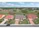 Aerial view of the property showcasing its well-manicured lawn, landscaping, and proximity to green space at 1972 Wolf Laurel Dr, Sun City Center, FL 33573
